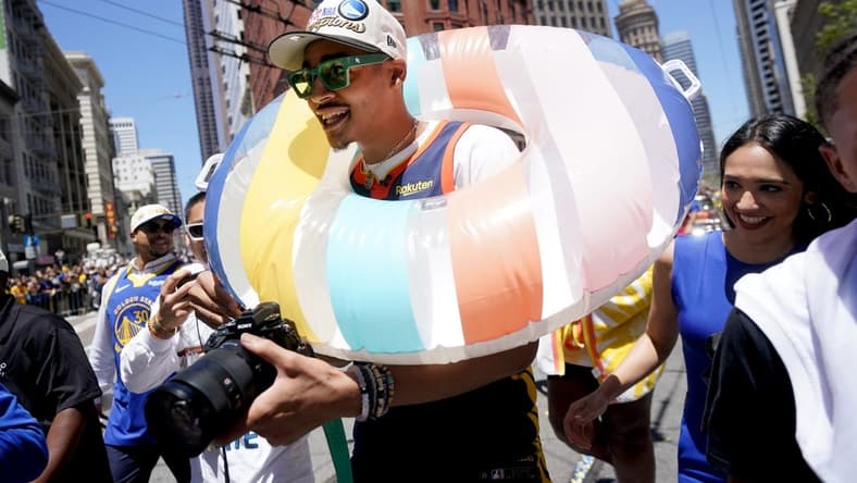 Jun 20, 2022; San Francisco, CA, USA; Golden State Warriors guard Jordan Poole wears a swim tube during the Warriors championship parade in downtown San Francisco. Mandatory Credit: Cary Edmondson-USA TODAY Sports