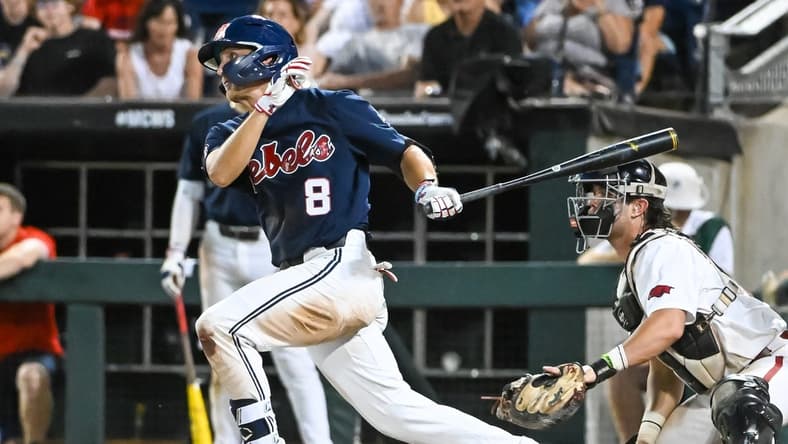 Jun 20, 2022; Omaha, NE, USA;  Ole Miss Rebels center fielder Justin Bench (8) drives in a run against the Arkansas Razorbacks in the eighth inning at Charles Schwab Field. Mandatory Credit: Steven Branscombe-USA TODAY Sports