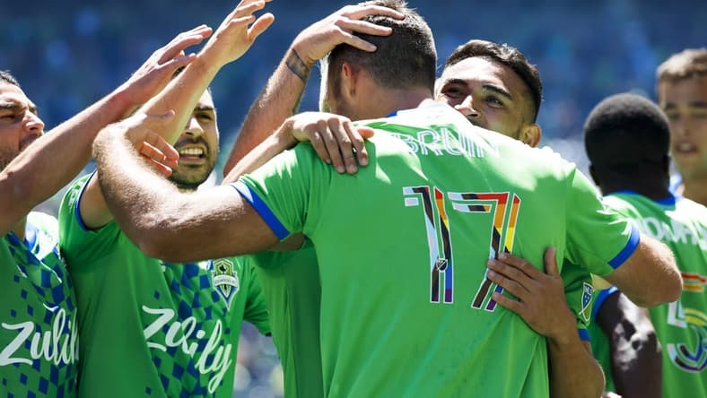 Jun 25, 2022; Seattle, Washington, USA; Seattle Sounders FC defender Will Bruin (17) celebrates with midfielder Nicolas Lodeiro (10, left), midfielder Alex Roldan (16, second from left) and midfielder Cristian Roldan (7, right) after scoring a goal against Sporting Kansas City during the first half at Lumen Field. Mandatory Credit: Joe Nicholson-USA TODAY Sports
