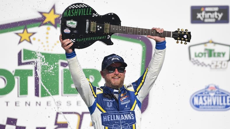 Jun 25, 2022; Nashville, Tennessee, USA; NASCAR Xfinity Series driver Justin Allgaier (7) celebrates in victory lane after winning the Xfinity Tennessee Lottery 250 at Nashville Superspeedway. Mandatory Credit: Christopher Hanewinckel-USA TODAY Sports