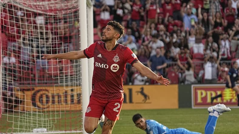 Jun 25, 2022; Toronto, Ontario, CAN; Toronto FC midfielder Jonathan Osorio (21) celebrates after scoring a goal against Atlanta United FC goalkeeper Rocco Rios Novo (34) during the first half at BMO Field. Mandatory Credit: John E. Sokolowski-USA TODAY Sports