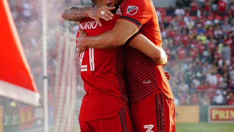 Jun 25, 2022; Toronto, Ontario, CAN;  Toronto FC midfielder Jonathan Osorio (21) celebrates with defender Carlos Salcedo (3) after scoring a goal against Atlanta United FC during the first half at BMO Field. Mandatory Credit: John E. Sokolowski-USA TODAY Sports