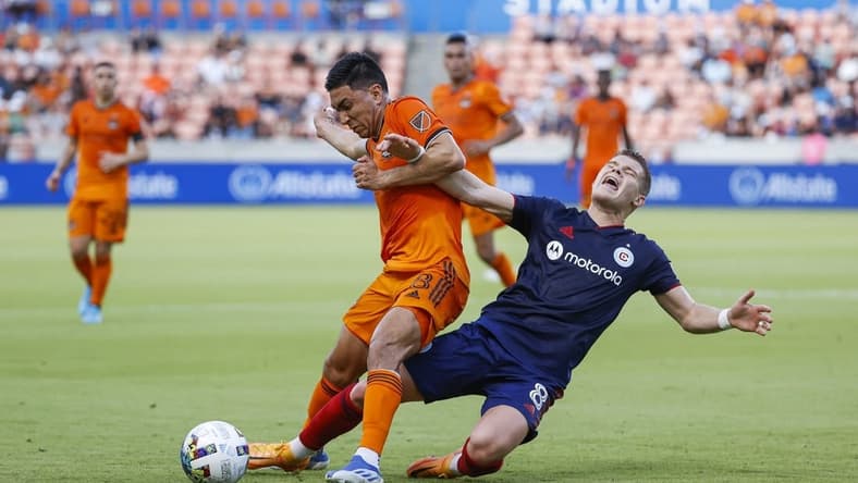 Jun 25, 2022; Houston, Texas, USA;  Houston Dynamo FC midfielder Memo Rodriguez (8) and Chicago Fire midfielder Chris Mueller (8) battle for the ball during the first half at PNC Stadium. Mandatory Credit: Troy Taormina-USA TODAY Sports