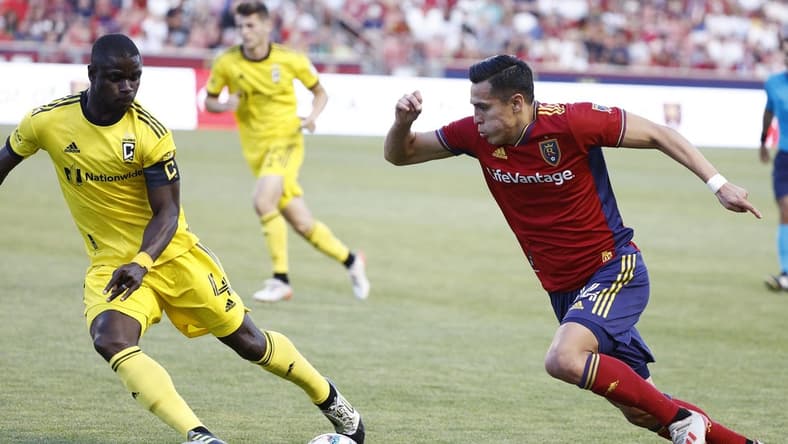 Jun 25, 2022; Sandy, Utah, USA; Real Salt Lake forward Rubio Rubin (14) looks to gets past Columbus Crew defender Jonathan Mensah (4) in the first half at Rio Tinto Stadium. Mandatory Credit: Jeffrey Swinger-USA TODAY Sports