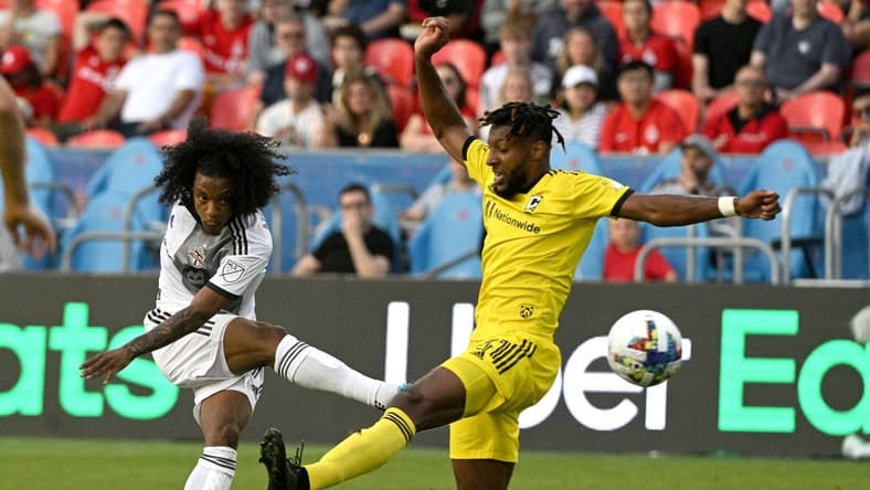Jun 29, 2022; Toronto, Ontario, CAN; Toronto FC midfielder Jayden Nelson (11) shoots the ball past Columbus Crew defender Steven Moreira (31) in the first half at BMO Field. Mandatory Credit: Dan Hamilton-USA TODAY Sports