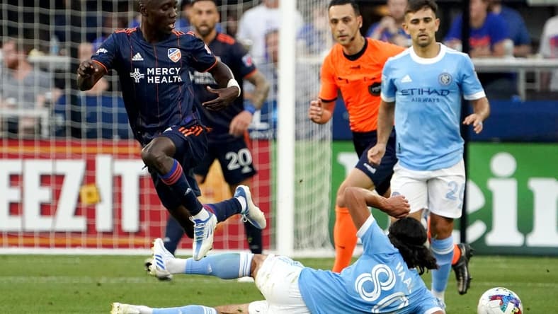 FC Cincinnati midfielder Obinna Nwobodo (5) passes the ball as New York City midfielder Justin Haak (80) goes for the slide tackle in the first half of an MLS soccer game, Wednesday, June 29, 2022, at TQL Stadium in Cincinnati.

New York City At Fc Cincinnati June 29 0021