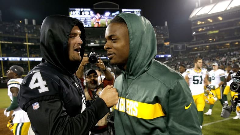 Raiders quarterback Derek Carr (4) and former Green Bay Packers wide receiver Davante Adams (17), pictured after the game at Oakland Coliseum. Mandatory Credit: Cary Edmondson-USA TODAY Sports