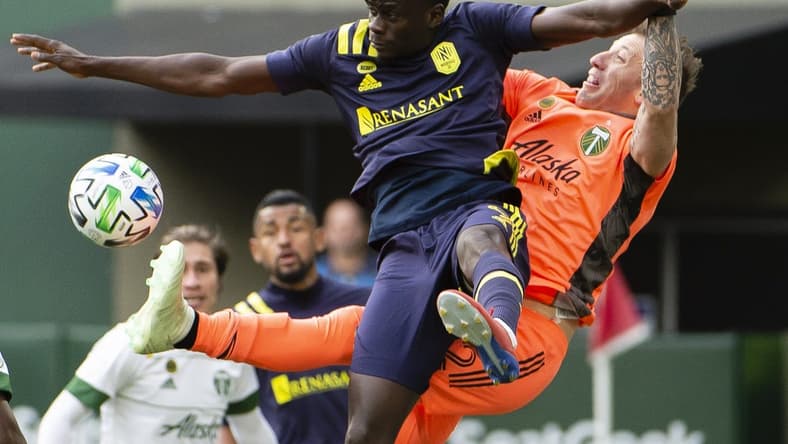 Mar 8, 2020; Portland, Oregon, USA; Portland Timbers goalkeeper Steve Clark (12) defends the goal during the second half against Nashville SC forward Dominique Badji (9) at Providence Park. The Timbers won 1-0. Mandatory Credit: Troy Wayrynen-USA TODAY Sports