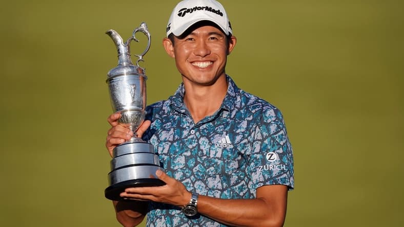 Jul 18, 2021; Sandwich, England, GBR; Collin Morikawa celebrates with the Claret Jug on the 18th green following his final round winning the Open Championship golf tournament. Mandatory Credit: Peter van den Berg-USA TODAY Sports