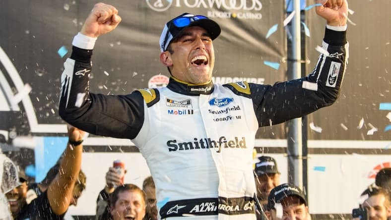 Jul 18, 2021; Loudon, New Hampshire, USA; NASCAR Cup Series driver Aric Almirola (10) celebrates after winning the Foxwoods Resort Casino 301 at the New Hampshire Motor Speedway. Mandatory Credit: Brian Fluharty-USA TODAY Sports