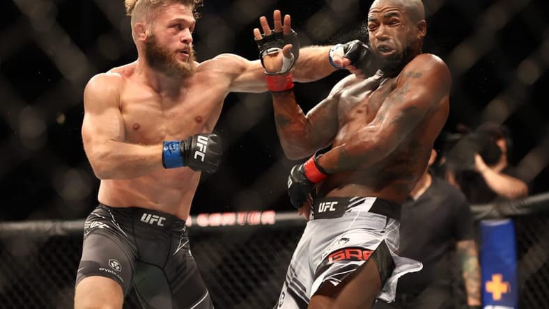 Aug 7, 2021; Houston, Texas, USA; Bobby Green (red gloves) fights Rafael Fiziev (blue gloves) during UFC 265 at Toyota Center. Mandatory Credit: Troy Taormina-USA TODAY Sports