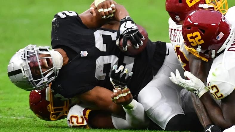 Dec 5, 2021; Paradise, Nevada, USA;Las Vegas Raiders running back Kenyan Drake (23) sustains an injury during a play against the Washington Football Team at Allegiant Stadium. Mandatory Credit: Stephen R. Sylvanie-USA TODAY Sports