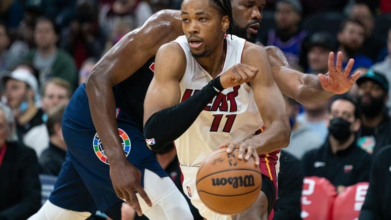 Dec 15, 2021; Philadelphia, Pennsylvania, USA; Miami Heat forward KZ Okpala (11) dribbles past Philadelphia 76ers center Joel Embiid (21) during the second quarter at Wells Fargo Center. Mandatory Credit: Bill Streicher-USA TODAY Sports