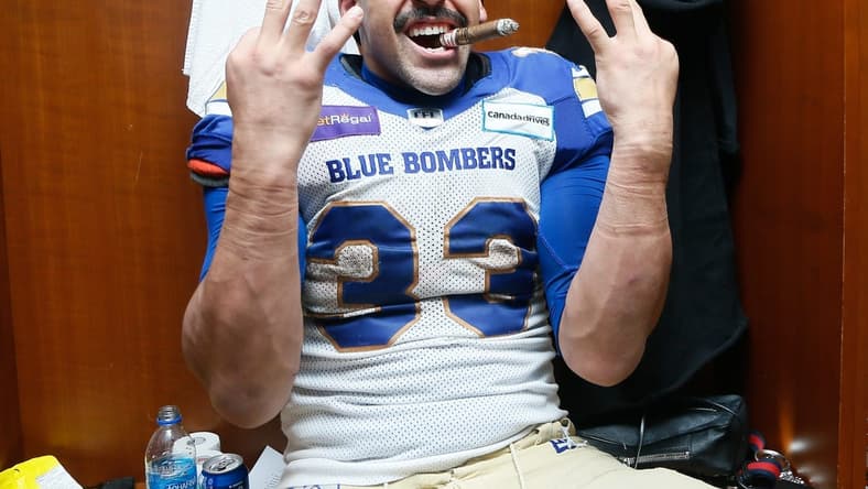 Dec 12, 2021; Hamilton, Ontario, CAN; Winnipeg Blue Bombers running back Andrew Harris (33) celebrates winning his third Grey Cup after a win over the Hamilton Tiger-Cats in the 108th Grey Cup football game at Tim Hortons Field. Mandatory Credit: John E. Sokolowski-USA TODAY Sports