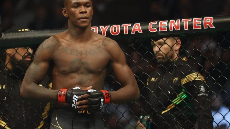 Feb 12, 2022; Houston, Texas, UNITED STATES; Israel Adesanya (red gloves) before the fight against Robert Whittaker (blue gloves) during UFC 271 at Toyota Center. Mandatory Credit: Troy Taormina-USA TODAY Sports