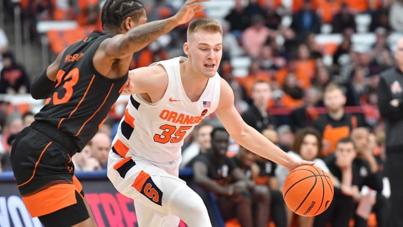 Mar 5, 2022; Syracuse, New York, USA; Syracuse Orange guard Buddy Boeheim (35) tries to move past Miami (Fl) Hurricanes guard Kameron McGusty (23) in the first half at the Carrier Dome. Mandatory Credit: Mark Konezny-USA TODAY Sports