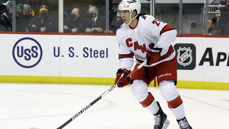 Mar 13, 2022; Pittsburgh, Pennsylvania, USA; Carolina Hurricanes defenseman Ethan Bear (25) handles the puck against the Pittsburgh Penguins during the second period at PPG Paints Arena. Mandatory Credit: Charles LeClaire-USA TODAY Sports