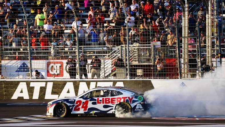 Mar 20, 2022; Hampton, Georgia, USA; NASCAR Cup Series driver William Byron (24) performs a burnout as he celebrates winning the Folds of Honor QuikTrip 500 at Atlanta Motor Speedway. Mandatory Credit: John David Mercer-USA TODAY Sports