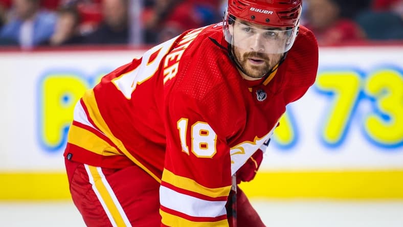 Apr 2, 2022; Calgary, Alberta, CAN; Calgary Flames center Ryan Carpenter (18) during the face off against the St. Louis Blues during the third period at Scotiabank Saddledome. Mandatory Credit: Sergei Belski-USA TODAY Sports