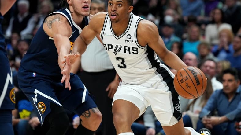 Apr 5, 2022; Denver, Colorado, USA; San Antonio Spurs forward Keldon Johnson (3) drives past Denver Nuggets forward Aaron Gordon (50) in the second half at Ball Arena. Mandatory Credit: Ron Chenoy-USA TODAY Sports