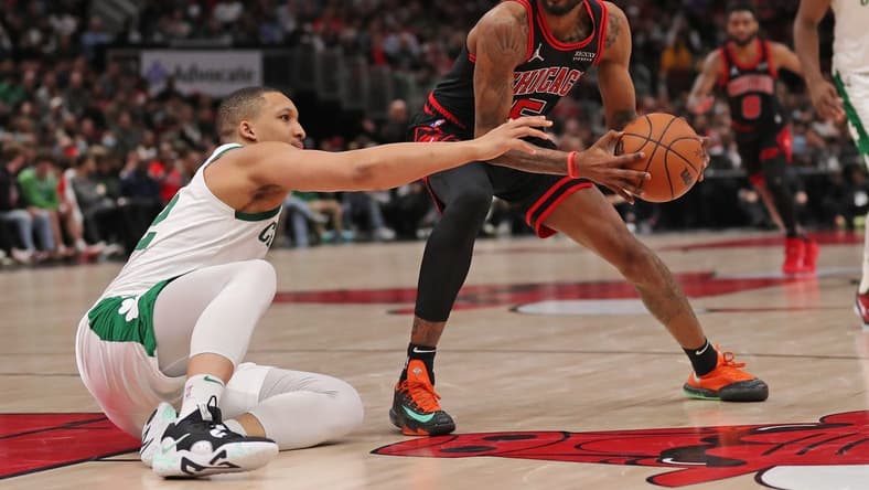 Apr 6, 2022; Chicago, Illinois, USA; Chicago Bulls forward Derrick Jones Jr. (5) being defended by Boston Celtics forward Grant Williams (12) during the second half at the United Center. Mandatory Credit: Dennis Wierzbicki-USA TODAY Sports
