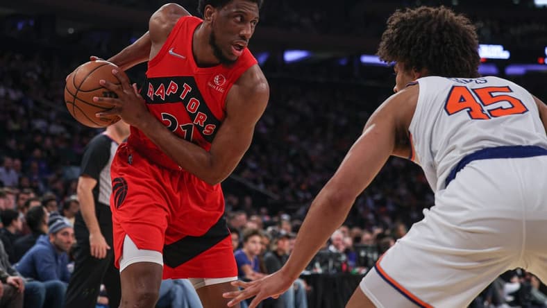 Apr 10, 2022; New York, New York, USA; Toronto Raptors forward Thaddeus Young (21) shields the ball from New York Knicks forward Jericho Sims (45) during the first half at Madison Square Garden. Mandatory Credit: Vincent Carchietta-USA TODAY Sports
