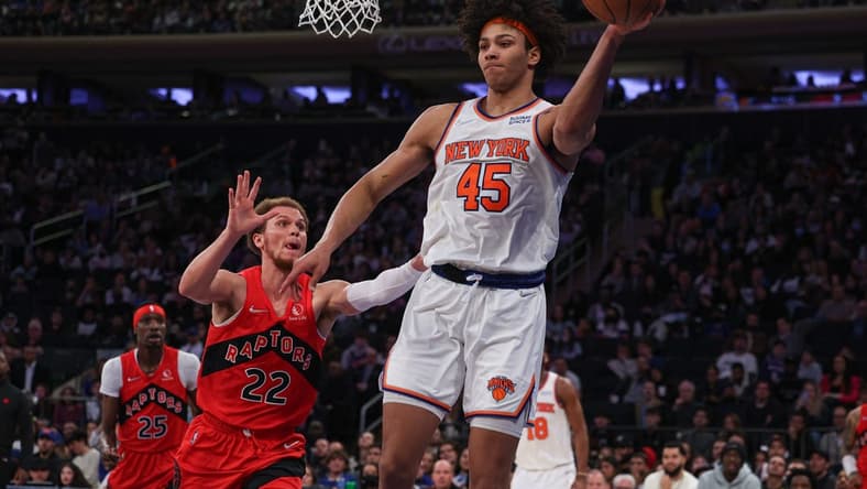 Apr 10, 2022; New York, New York, USA; New York Knicks forward Jericho Sims (45) passes the ball as Toronto Raptors guard Malachi Flynn (22) defends during the second half at Madison Square Garden. Mandatory Credit: Vincent Carchietta-USA TODAY Sports