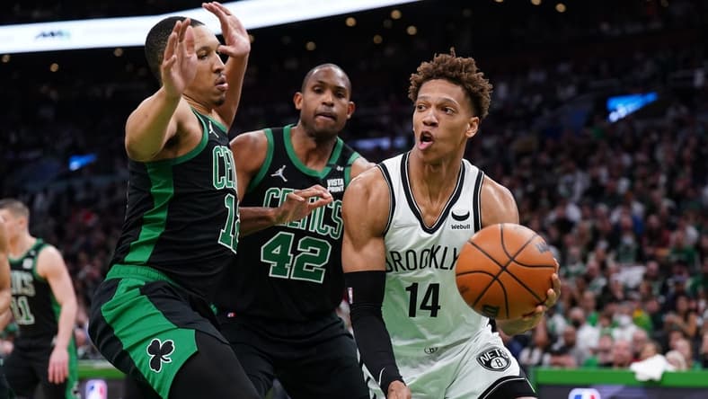 Apr 17, 2022; Boston, Massachusetts, USA; Brooklyn Nets forward Kessler Edwards (14) drives the ball against Boston Celtics forward Grant Williams (12) and center Al Horford (42) in the first quarter during game one of the first round for the 2022 NBA playoffs at TD Garden. Mandatory Credit: David Butler II-USA TODAY Sports