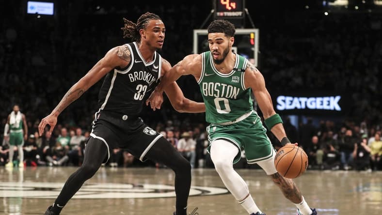 Apr 23, 2022; Brooklyn, New York, USA; Boston Celtics forward Jayson Tatum (0) drives past Brooklyn Nets forward Nic Claxton (33) in the first quarter at Barclays Center. Mandatory Credit: Wendell Cruz-USA TODAY Sports