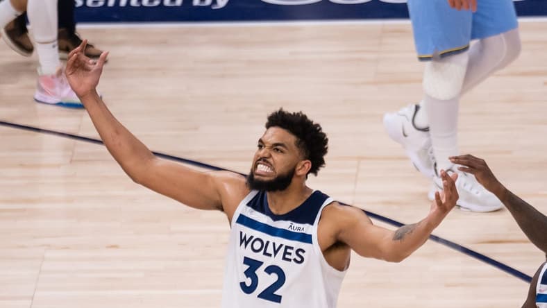 Apr 23, 2022; Minneapolis, Minnesota, USA; Minnesota Timberwolves center Karl-Anthony Towns (32) celebrates against the Memphis Grizzlies in the third quarter during game four of the first round for the 2022 NBA playoffs at Target Center. Mandatory Credit: Brad Rempel-USA TODAY Sports