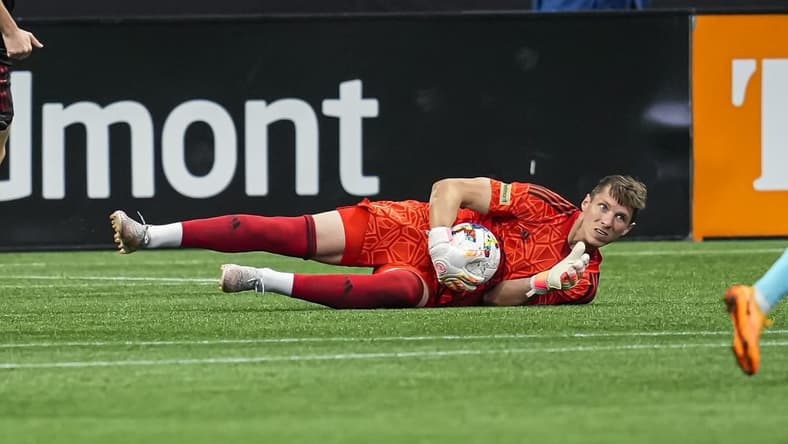 May 15, 2022; Atlanta, Georgia, USA; Atlanta United goalkeeper Bobby Shuttleworth (18) dives on the ball against the New England Revolution during the first half at Mercedes-Benz Stadium. Mandatory Credit: Dale Zanine-USA TODAY Sports