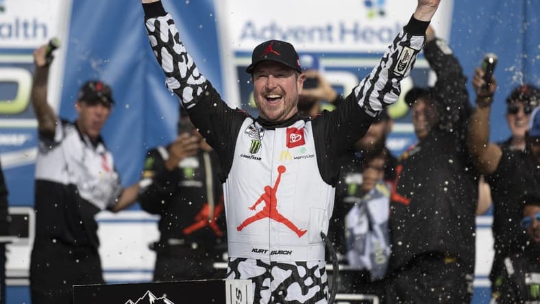 May 15, 2022; Kansas City, Kansas, USA; NASCAR Cup Series driver Kurt Busch (45) celebrates on victory lane after winning the AdventHealth 400 at Kansas Speedway. Mandatory Credit: Amy Kontras-USA TODAY Sports