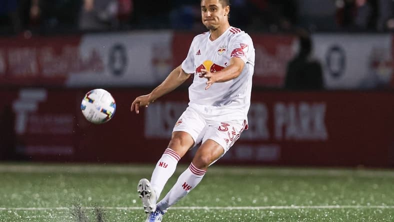 May 25, 2022; Montclair, New Jersey, USA; New York Red Bulls midfielder Aaron Long (33) kicks the ball against Charlotte FC  during the first half at Montclair State University Soccer Park. Mandatory Credit: Vincent Carchietta-USA TODAY Sports