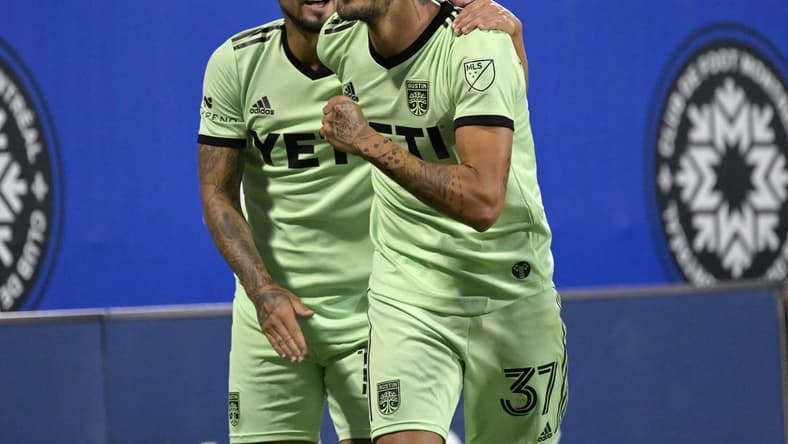 Jun 18, 2022; Montreal, Quebec, CAN; Austin FC forward Maximiliano Urruti (37) celebrates with teammate Austin FC midfielder Diego Fagundez (14) after scoring a goal against the CF Montreal during the second half at Stade Saputo. Mandatory Credit: Eric Bolte-USA TODAY Sports