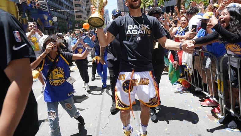 Jun 20, 2022; San Francisco, CA, USA; Golden State Warriors guard Stephen Curry interacts with fans during the Warriors championship parade in downtown San Francisco. Mandatory Credit: Cary Edmondson-USA TODAY Sports