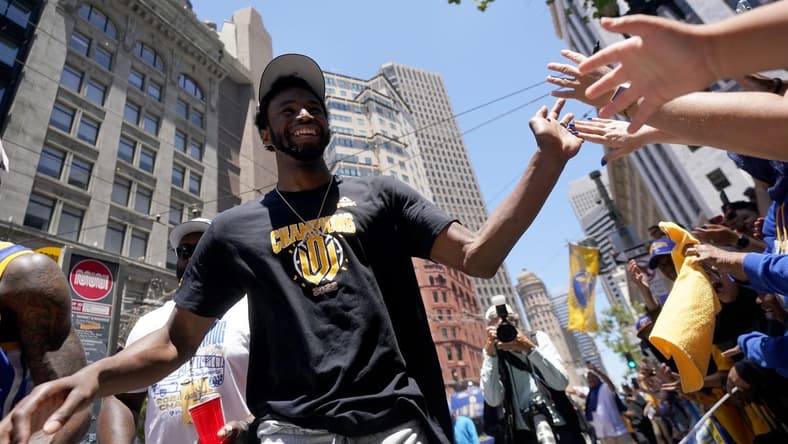 Jun 20, 2022; San Francisco, CA, USA; Golden State Warriors forward Andrew Wiggins gives high fives to fans during the Warriors championship parade in downtown San Francisco. Mandatory Credit: Cary Edmondson-USA TODAY Sports