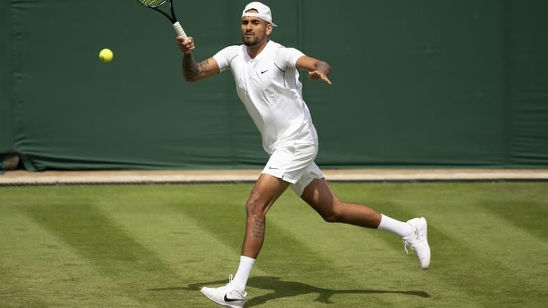 Jun 28, 2022; London, United Kingdom; Nick Kyrgios (AUS) returns a shot during her first round match against Paul Gubb (GBR) on day two at All England Lawn Tennis and Croquet Club. Mandatory Credit: Susan Mullane-USA TODAY Sports