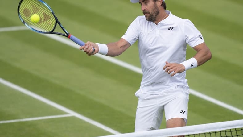 Jun 29, 2022; London, United Kingdom; Steve Johnson (USA) returns a shot during his second round match against Ryan Peniston (GBR) on day three at All England Lawn Tennis and Croquet Club. Mandatory Credit: Susan Mullane-USA TODAY Sports