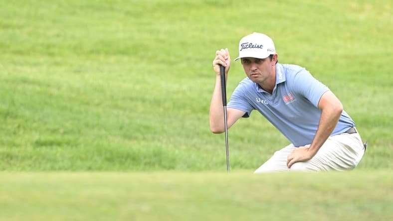 Jul 1, 2022; Silvis, Illinois, USA; J.T. Poston lines up a putt on the 1st hole during the second round of the John Deere Classic golf tournament. Mandatory Credit: Marc Lebryk-USA TODAY Sports