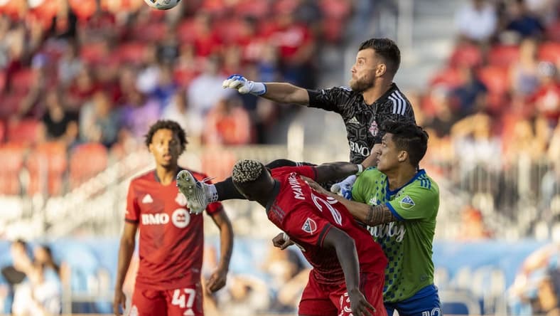 Jul 2, 2022; Toronto, Ontario, CAN; Toronto FC goalkeeper Quentin Westberg (16) makes a save against Seattle Sounders forward Fredy Montero (12) during the first half at BMO Field. Mandatory Credit: Kevin Sousa-USA TODAY Sports