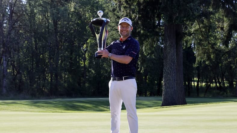 Jul 2, 2022; Portland, Oregon, USA; Branden Grace poses with the trophy after winning the LIV Golf tournament at Pumpkin Ridge Golf Club. Mandatory Credit: Soobum Im-USA TODAY Sports