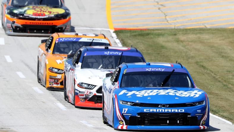 Kyle Larson (17) leads a pack for a pit stop duirng the NASCAR Xfinity Series Henry 180 at Road America, Saturday, July 2, 2022, in Elkhart Lake, Wis.