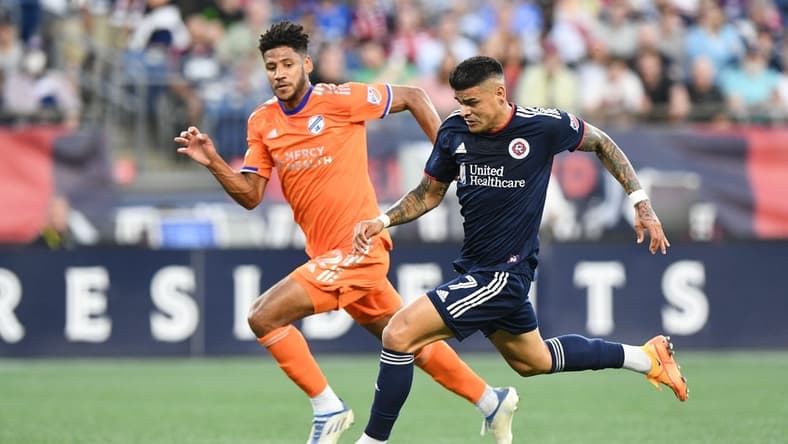 Jul 3, 2022; Foxborough, Massachusetts, USA; New England Revolution forward Gustavo Bou (7) controls the ball in front of FC Cincinnati defender Ian Murphy (32) during the first half at Gillette Stadium. Mandatory Credit: Brian Fluharty-USA TODAY Sports