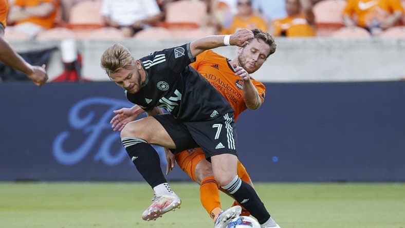 Jul 3, 2022; Houston, Texas, USA; Charlotte FC midfielder Kamil Jozwiak (7) and Houston Dynamo FC defender Adam Lundqvist (3) battle for the ball during the first half at PNC Stadium. Mandatory Credit: Troy Taormina-USA TODAY Sports