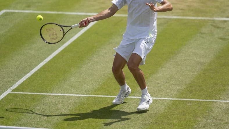 Jul 4, 2022; London, United Kingdom; Alex De Minaur (AUS) returns a shot during his match against Cristian Garin (CHI) on day eight at All England Lawn Tennis and Croquet Club. Mandatory Credit: Susan Mullane-USA TODAY Sports