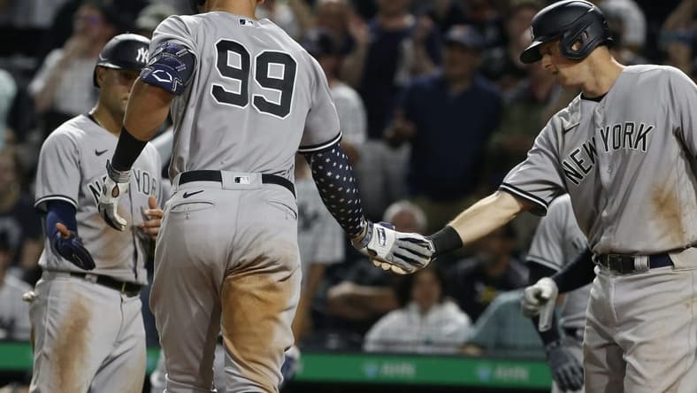 Jul 6, 2022; Pittsburgh, Pennsylvania, USA; New York Yankees shortstop Isiah Kiner-Falefa (left) and first  baseman DJ LeMahieu (right) congratulate center fielder Aaron Judge (99) after hitting a grand slam home run against the Pittsburgh Pirates during the eighth inning at PNC Park. Mandatory Credit: Charles LeClaire-USA TODAY Sports
