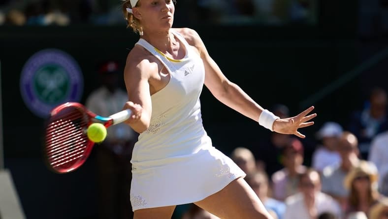 Jul 7, 2022; London, England, United Kingdom;  Elena Rybakina (KAZ) returns a shot during her semi-finals women   s singles match against Simona Halep (ROU) on Centre court at All England Lawn Tennis and Croquet Club. Mandatory Credit: Peter van den Berg-USA TODAY Sports