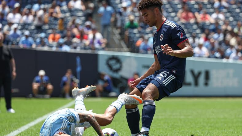 Jul 9, 2022; New York, New York, USA; New York City FC midfielder Santiago Rodriguez (20) collides with New England Revolution midfielder Brandon Bye (15) during the first half at Yankee Stadium. Mandatory Credit: Vincent Carchietta-USA TODAY Sports