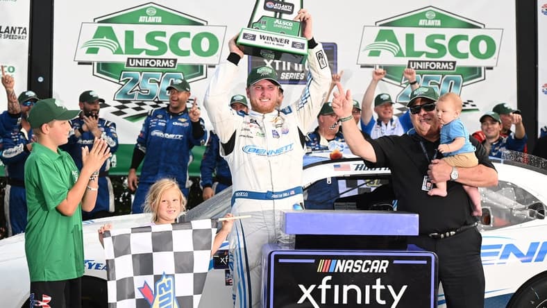 Jul 9, 2022; Hampton, Georgia, USA; NASCAR Xfinity Series driver Austin Hill (21) celebrates with the trophy after winning the Alsco Uniforms 250 at Atlanta Motor Speedway. Mandatory Credit: Adam Hagy-USA TODAY Sports