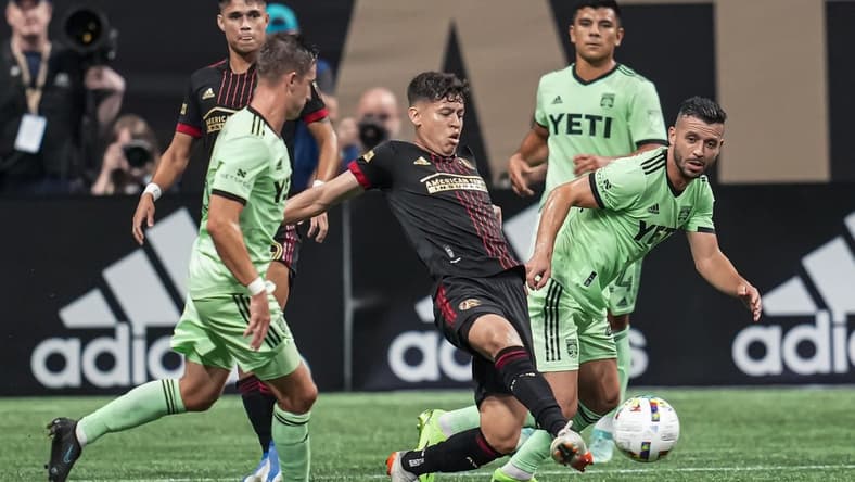 Jul 9, 2022; Atlanta, Georgia, USA; Atlanta United midfielder Matheus Rossetto (9) kicks the ball against Austin FC midfielder Felipe Martins (22) during the first half at Mercedes-Benz Stadium. Mandatory Credit: Dale Zanine-USA TODAY Sports